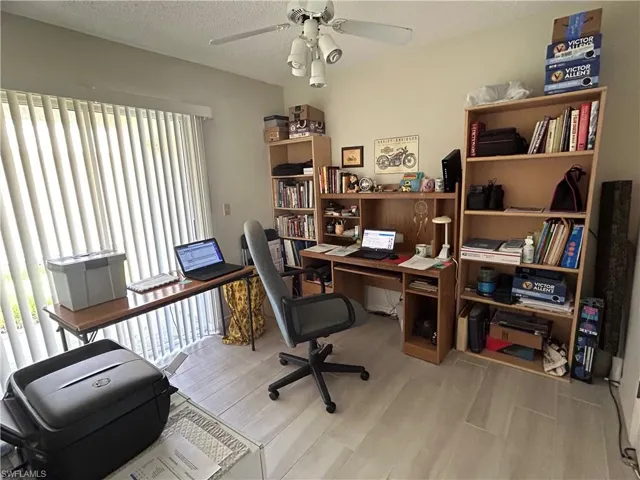 Office space or third bedroom with ceiling fan, light hardwood / wood-style floors, and a textured ceiling