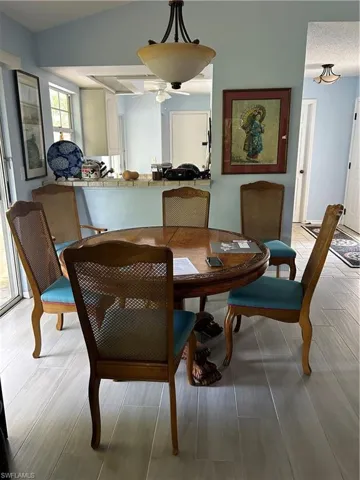 Dining room featuring ceiling fan and vaulted ceiling