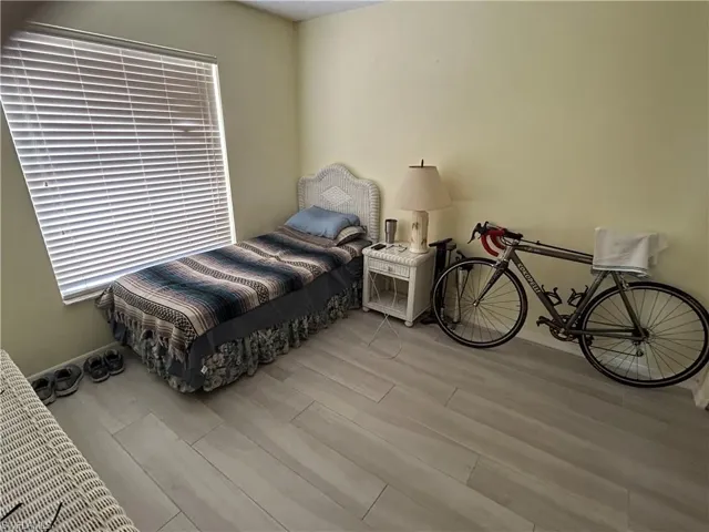Bedroom with light hardwood / wood-style flooring