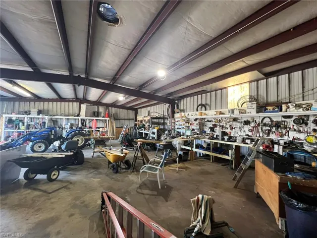 Garage featuring metal wall and a workshop area