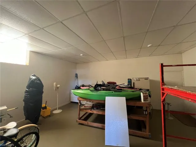 Game room featuring finished concrete floors and a drop ceiling