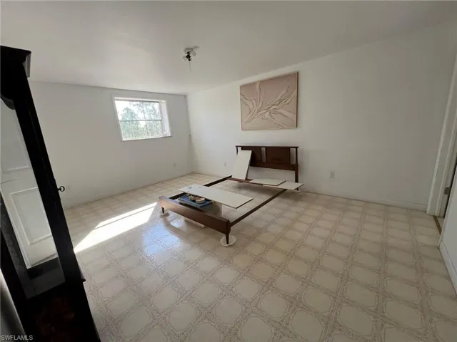 Unfurnished living room featuring tile patterned floors