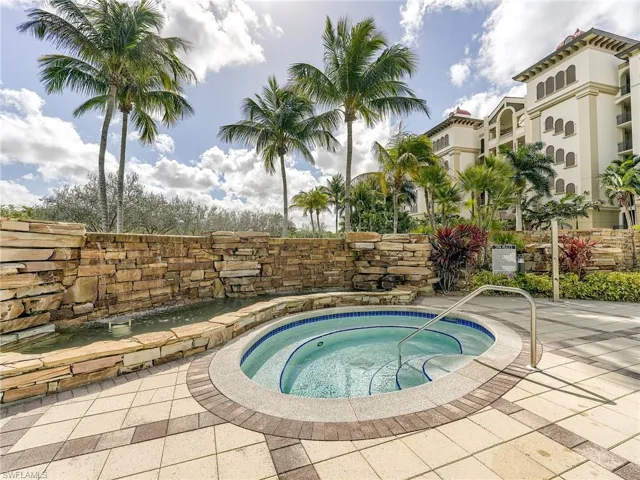 View of pool featuring a hot tub
