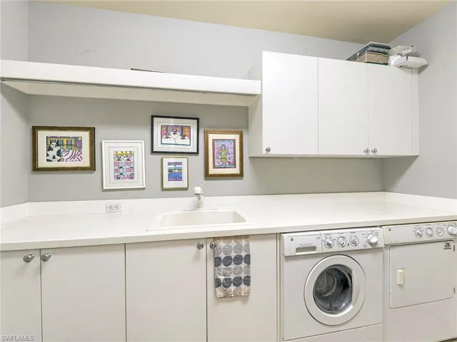 Laundry area with washing machine and clothes dryer and cabinet space