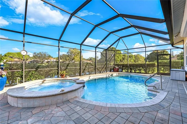 Private screened pool and spa with expansive paver deck and easy access to the covered outdoor living area. Plenty of covered area for those relaxing afternoons pool side.
