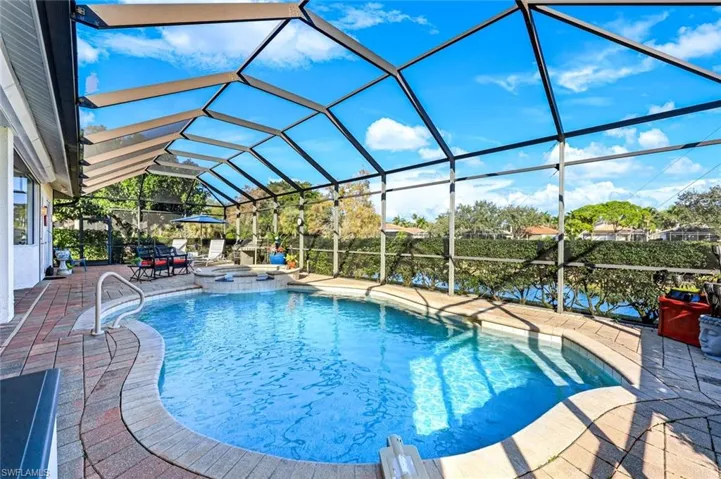 Screened-in pool and patio area overlooking the lake, offering a private outdoor setting for relaxing or entertaining friends and family.