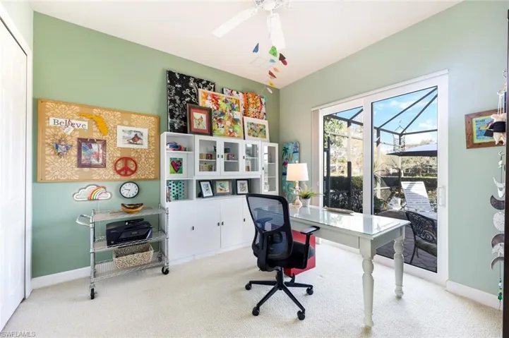 Versatile den or creative workspace featuring built-in cabinetry, ample counter space, and large windows for natural light. With the closets, this could be another guest bedroom.