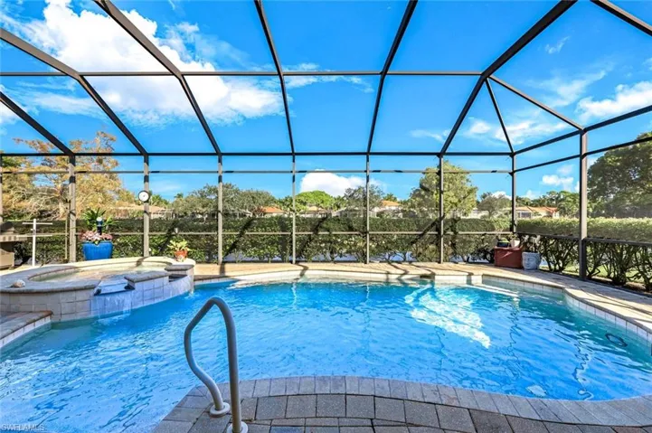 Screened pool and spa area with paver deck, lake views, and plenty of space for outdoor enjoyment. Plenty of space for entertaining around the pool.