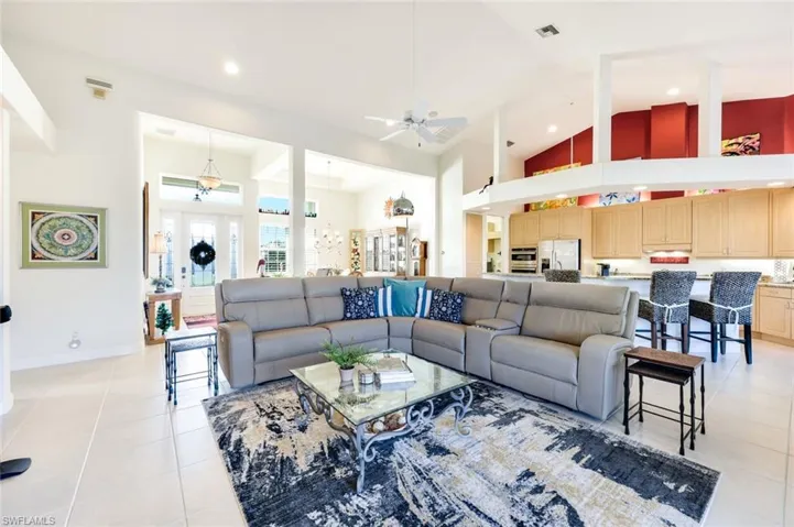 Bright and open living area with ample seating and an open-concept layout connecting to the kitchen and dining area.