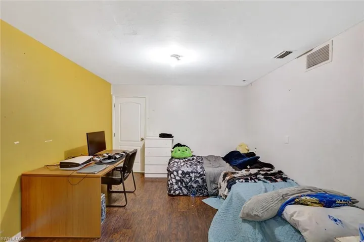 Den with French doors being used as a bedroom