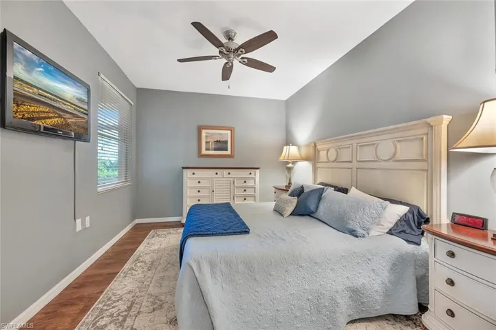 Bedroom featuring wood finished floors, ceiling fan, and baseboards
