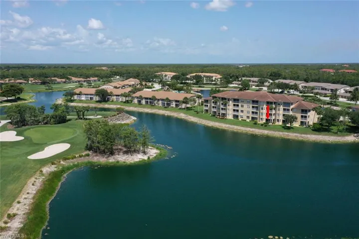 Drone / aerial view of a large body of water and a golf course