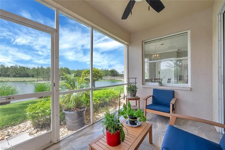 Sunroom featuring a water view and ceiling fan
