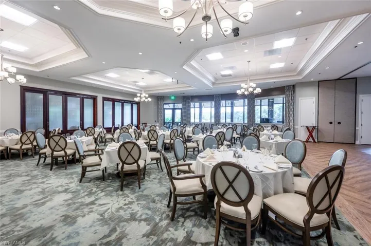 Dining room featuring a chandelier, a tray ceiling, and ornamental molding