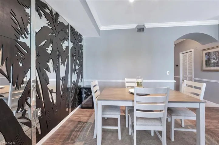 Dining area featuring arched walkways, ornamental molding, and baseboards