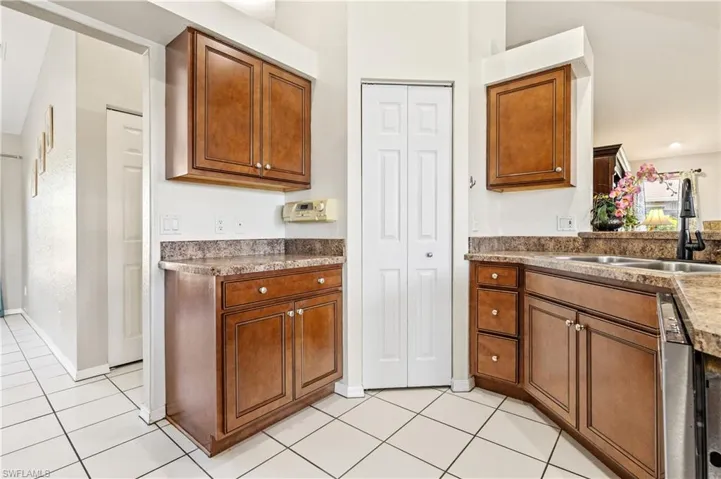 Kitchen featuring wood finish cabinetry and light tile patterned flooring