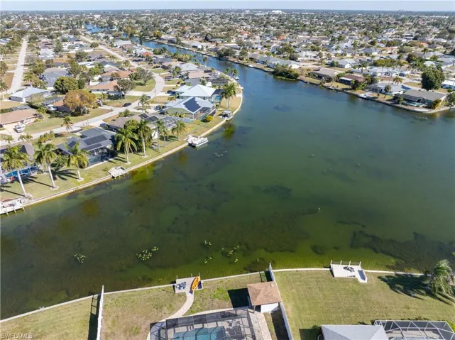 Aerial perspective of suburban area featuring a large body of water