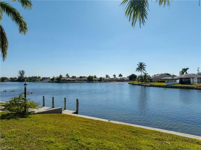 Dock featuring a water view and a lawn