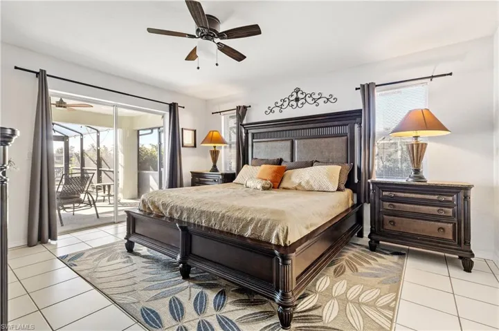 Bedroom with ceiling fan, access to exterior, and light tile patterned floors