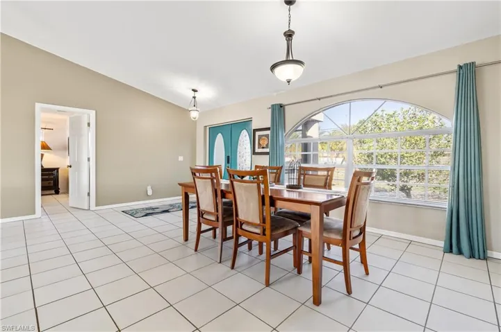 Dining room featuring vaulted ceiling and light tile patterned floors