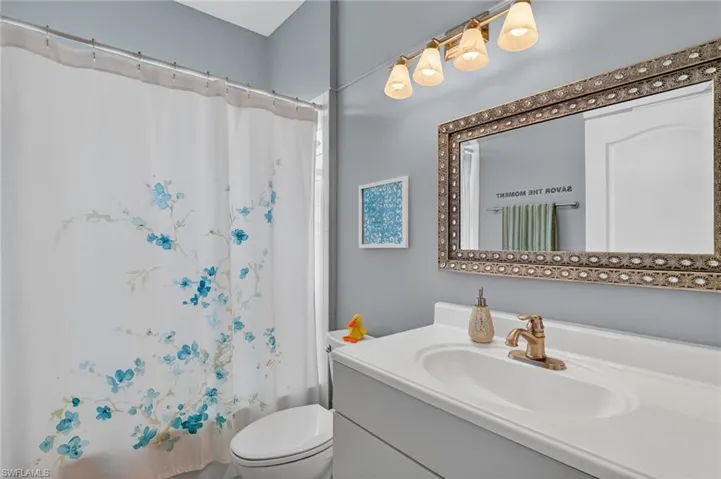 Bathroom featuring shower / tub combo and vanity