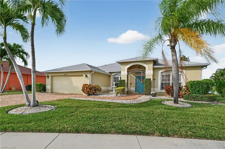 View of front of house featuring stucco siding, a front lawn, decorative driveway, and a garage