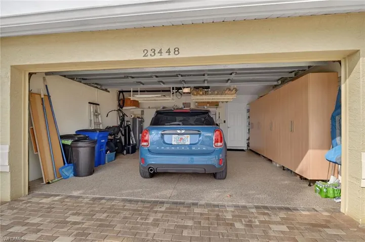 Garage with epoxy floor, extra cabinet and over head storage.