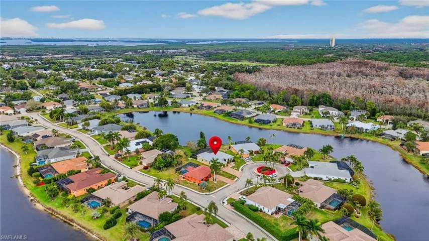 View of property location featuring a nearby body of water and nearby suburban area