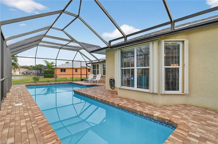 Swimming regular and lap pool with a patio area, a sunroom, and a lanai
