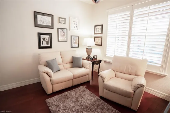 Sitting room featuring dark wood-type flooring