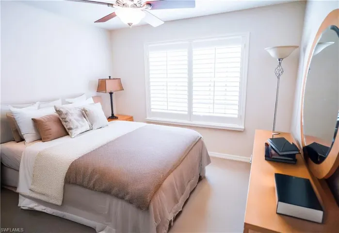 Carpeted bedroom with ceiling fan