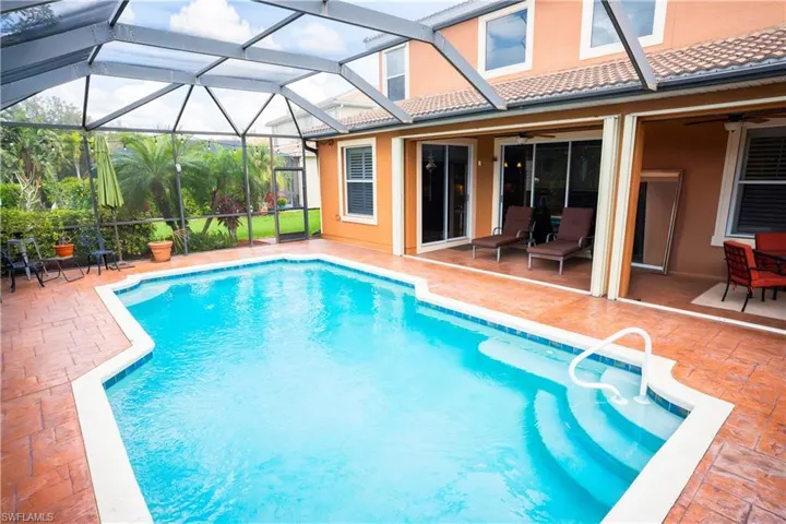 View of pool with a patio, a lanai, and ceiling fan