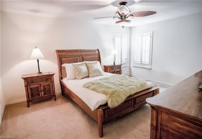 Bedroom featuring light carpet and ceiling fan