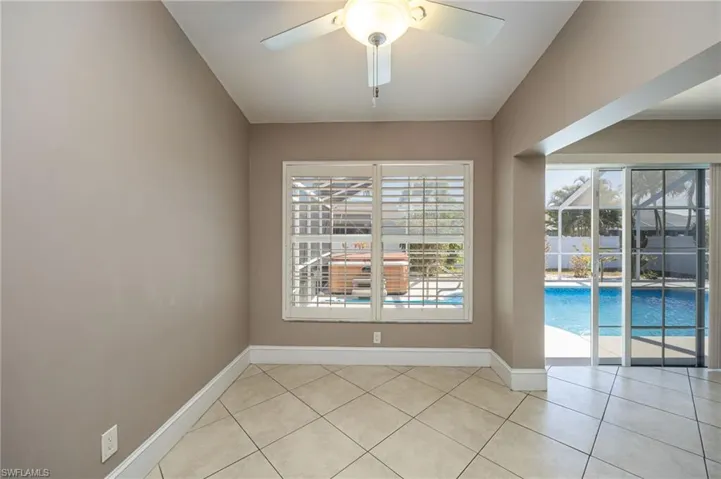 Dining area featuring ceiling fan, plenty of natural light, light tile patterned flooring, and lofted ceiling