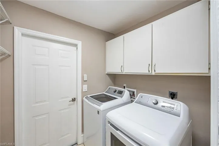 In unit laundry area featuring cabinet space and separate washer and dryer