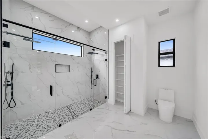 Bathroom with toilet and walk in shower