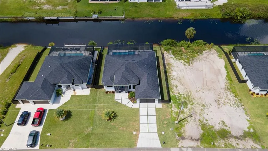 Birds eye view of property with a water view