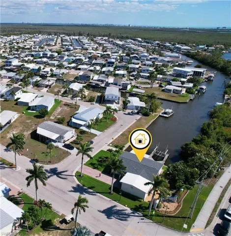 Aerial view showcasing corner lot location and canal frontage