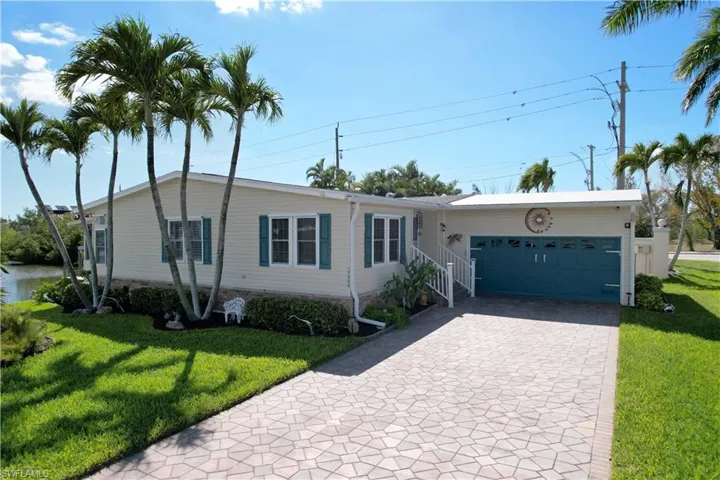 Well maintained exterior with paver driveway and two car garage