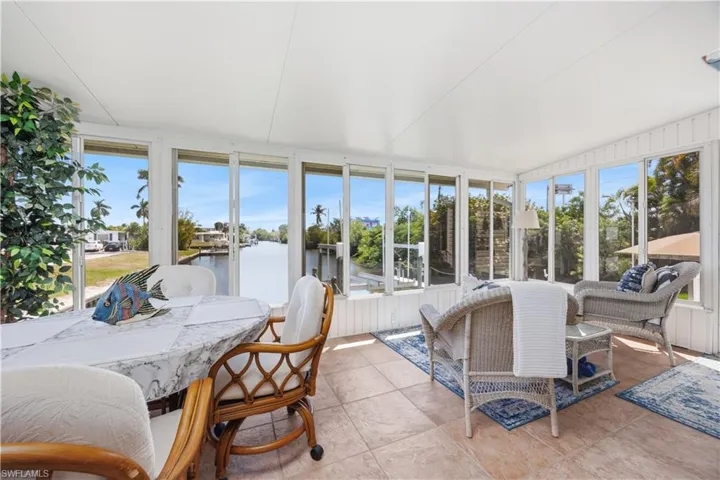 Spacious enclosed lanai with panoramic canal views