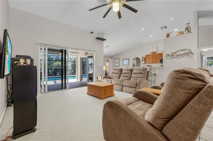 Living room featuring recessed lighting, visible vents, high vaulted ceiling, and a ceiling fan