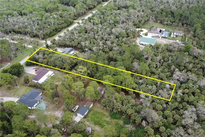 Aerial view featuring a wooded view