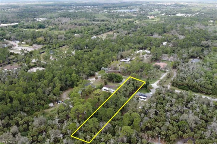 Aerial view featuring a wooded view