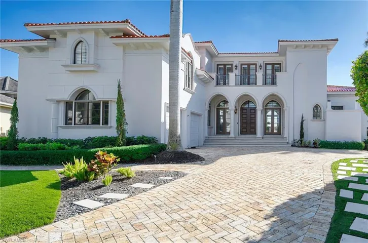 Mediterranean / spanish-style home featuring a balcony and french doors
