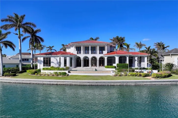 Rear view of property featuring a balcony and a water view