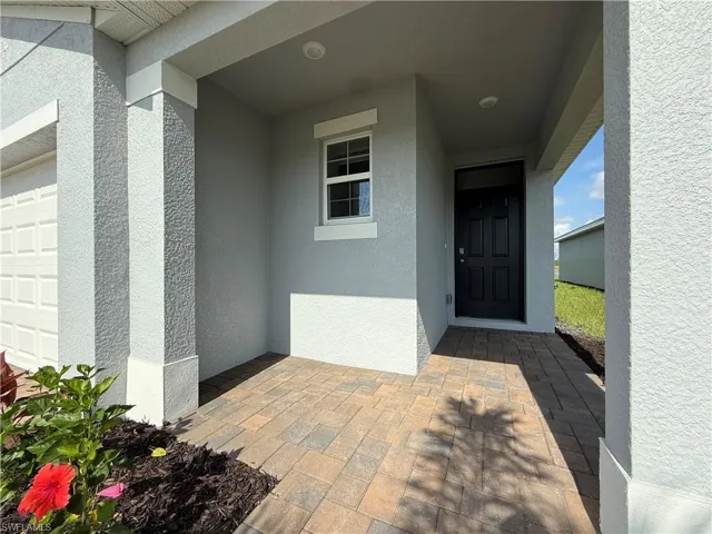 Property entrance featuring stucco siding
