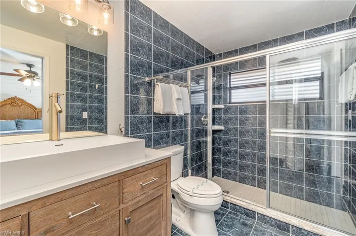 Master bathroom featuring wood vanity and a walk-in shower