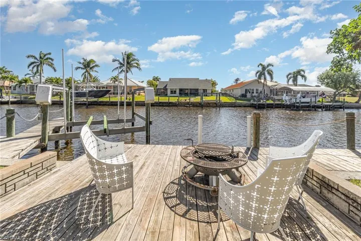 Dock area with boat lift and a water view