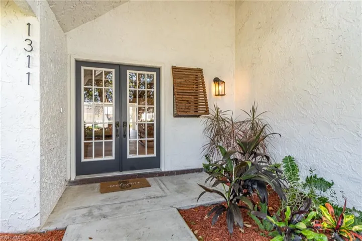 Property entrance featuring french doors and stucco siding