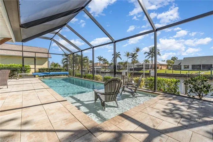 Heated outdoor saltwater pool featuring enclosed lanai